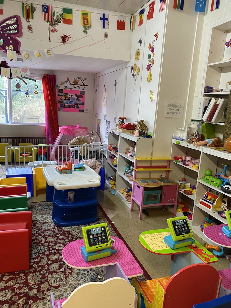 A vibrant playroom filled with colorful toys and furniture, creating a cheerful and inviting space for children to play.
